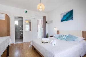 a bedroom with a bed with a hat and towels on it at Apartments Nikolic in Gradac