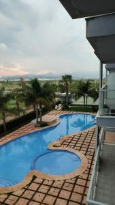 a view of a swimming pool from a building at Lovely 1bed apartment with padel court near beach in Moncófar