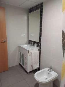 a white bathroom with a sink and a mirror at Lovely 1bed apartment with padel court near beach in Moncófar