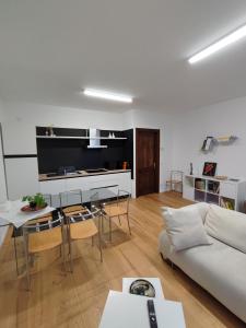 a living room with a white couch and a table at La Casa di Priscilla in Fagagna