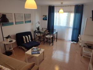 a living room with a couch and a table at Appartamento in Oasis tropicale in Corralejo