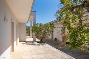 an internal courtyard of a house with trees at Corte dei Melograni Hotel Resort in Otranto