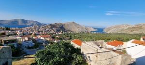 a view of a town with a city and water at LA CASA DI MARCONI in Symi