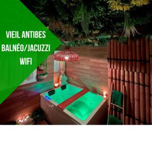a swimming pool in a room with avertisement for avertisementosateosateosateosate at Le balneo jacuzzi Vieil Antibes Safranier in Antibes