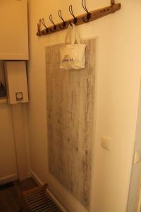 a bathroom with a wooden door with a bag on it at Ferienwohnung-Meeresrauschen in Großenbrode