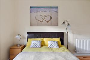 a bedroom with a bed with two hearts on the wall at Modern and Spacious flat near Edinburgh in Prestonpans
