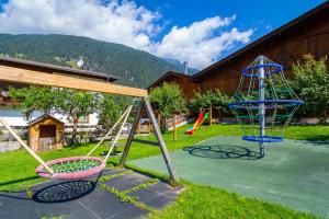 a playground with a swing set and a slide at Aparthaus Alpenzauber in Neustift im Stubaital