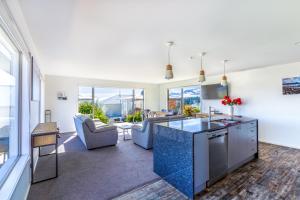 a kitchen and living room with a couch and a table at Tekapo Blue in Lake Tekapo