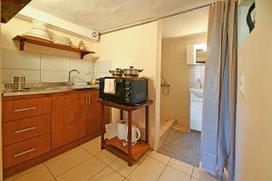a small kitchen with a microwave on a table at Stone house for relaxation in Elos in Kissamos
