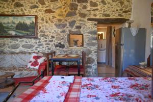 A bed or beds in a room at Stone house for relaxation in Elos