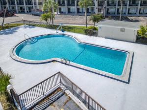 a large swimming pool with stairs next to a building at Stayable St Augustine in St. Augustine