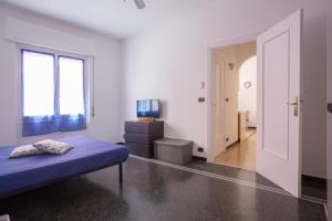 a bedroom with a bed and a tv in it at La Casetta Blu in Genoa