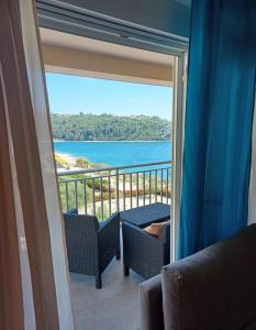 a room with a balcony with a view of the ocean at Sol in Kremena