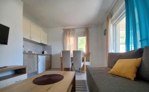 a living room with a couch and a table and a kitchen at Sol in Kremena