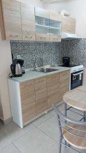 a kitchen with a sink and a table at Dream in Kavala 2020 renovated, sunny apartment in Kavála