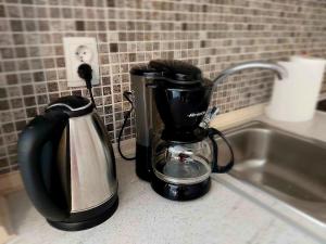 a coffee maker and a toaster on a kitchen counter at Dream in Kavala 2020 renovated, sunny apartment in Kavála