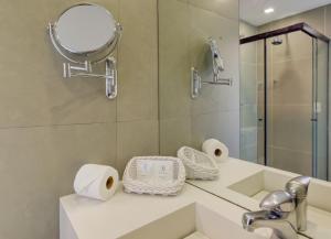 a bathroom with a sink and a mirror at Rio Design Copacabana Hotel in Rio de Janeiro