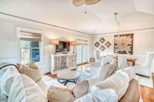a living room with a white couch and a table at Lighthouse Loft in Santa Rosa Beach