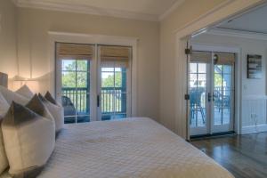 a bedroom with a bed and a balcony at Lighthouse Loft in Santa Rosa Beach +37 photos