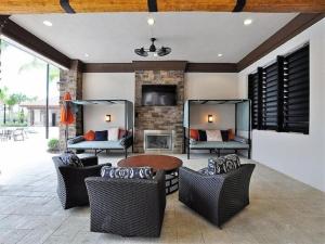a patio with chairs and a table and a fireplace at Summer Breeze Villa in Davenport
