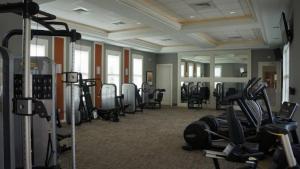 a gym with many treadmills and machines in a room at Summer Breeze Villa in Davenport