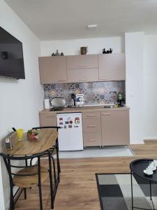 een keuken met een houten tafel en een tafel en een tafel en een tafel bij Apartman Dia Sarajevo in Sarajevo