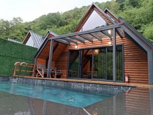 a log cabin with a pool in front of it at Naturkoy Sapanca in Sakarya