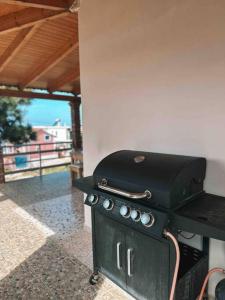 a grill on a table in a patio at Paradise House in Arkoudi