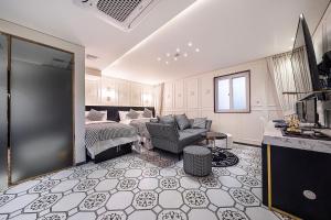 a living room with a bed and a couch at Jongno Olive Hotel in Seoul