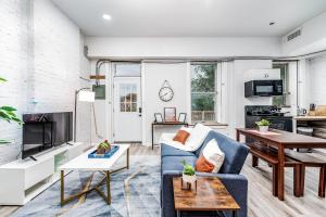 a living room with a blue couch at Park Ave Townhome w parking by CozySuites in Saint Louis