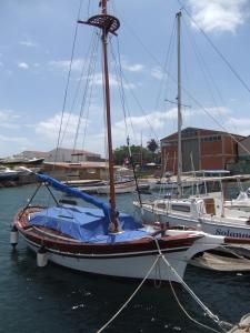 a sailboat is docked at a dock in the water at B&B La Pineta in SantʼAntìoco