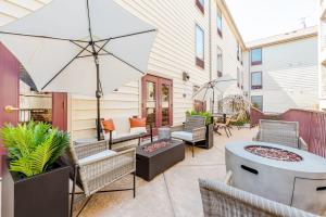 a patio with a grill and an umbrella at CozySuites CWE 2 queen bed suite in Saint Louis