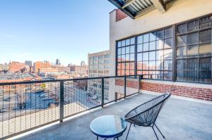 a balcony with two chairs and a table on it at CozySuites Stunning 2BR penthouse Skyline view in Saint Louis