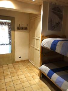 a bedroom with two bunk beds and a window at Appartement 4 à 6 personnes aux portes du parc de la vanoise in Champagny-en-Vanoise