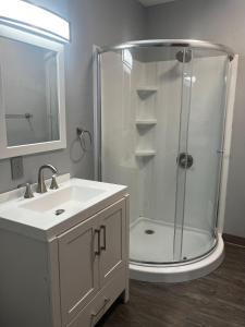 a white bathroom with a shower and a sink at Simple Deluxe Private Room in Anchorage