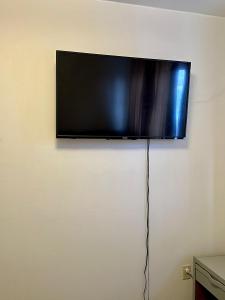a flat screen tv hanging on a wall at Simple Deluxe Private Room in Anchorage