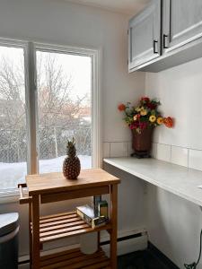 a small kitchen with a table and a window at Simple Deluxe Private Room in Anchorage