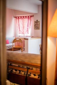 a small room with a bed and a window at ZeusPlace Park View Apartment Paralia Katerini in Paralia Katerinis