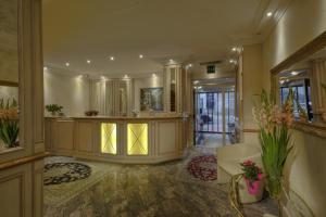 a large room with a lobby with a reception desk at Hotel Condor in Munich