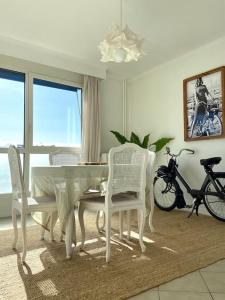 une salle à manger avec une table et des chaises blanches dans l'établissement Bel appartement idéalement situé, à Valence
