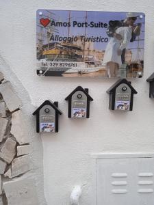 una señal en el lado de un edificio con pájaros en él en Amos Port-Suite, en Civitavecchia