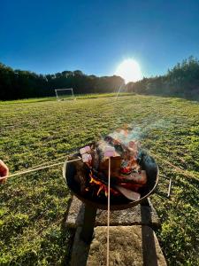 a bbq on a stand in a field at Highgate Mountain in Pembrokeshire