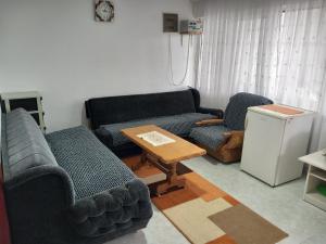 a living room with two couches and a table at TOMI Apartment in Ulcinj
