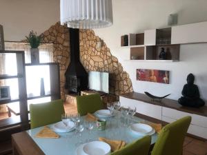 a dining room with a table and a fireplace at Mirariu in Els Muntells
