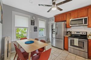 a kitchen with a wooden table and a dining room at Cozy house close to Brandeis, Bentley, Moody St in Waltham