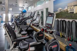 a gym with a row of cardio machines and a cell phone at Spice in Santa Rosa Beach