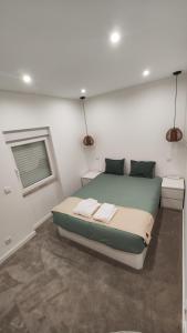 um quarto com uma cama com duas toalhas em Monsanto Central Park em Lisboa