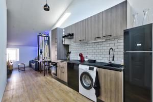 a kitchen with a sink and a dishwasher at le karibu appartement confort tout équipé in Lagnieu