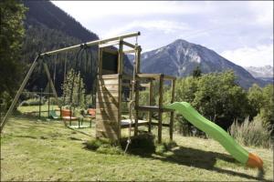 a playground in a field with a slide at Appartement 4 à 6 personnes aux portes du parc de la vanoise in Champagny-en-Vanoise