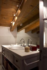 a bathroom with a sink with two faucets at B&B Il Posto delle Rose in Almenno San Salvatore